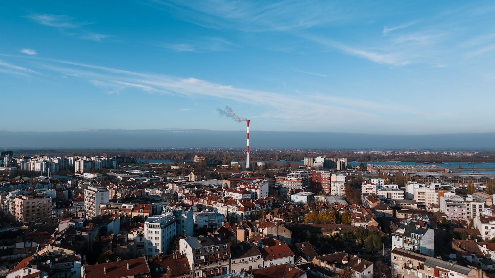 A stunning aerial view of Belgrade, Serbia featuring urban architecture and a prominent smoke stack.