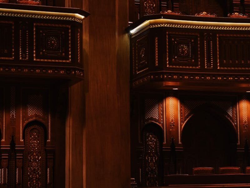 Intricate wooden detailing inside the Royal Opera House Muscat with plush seating