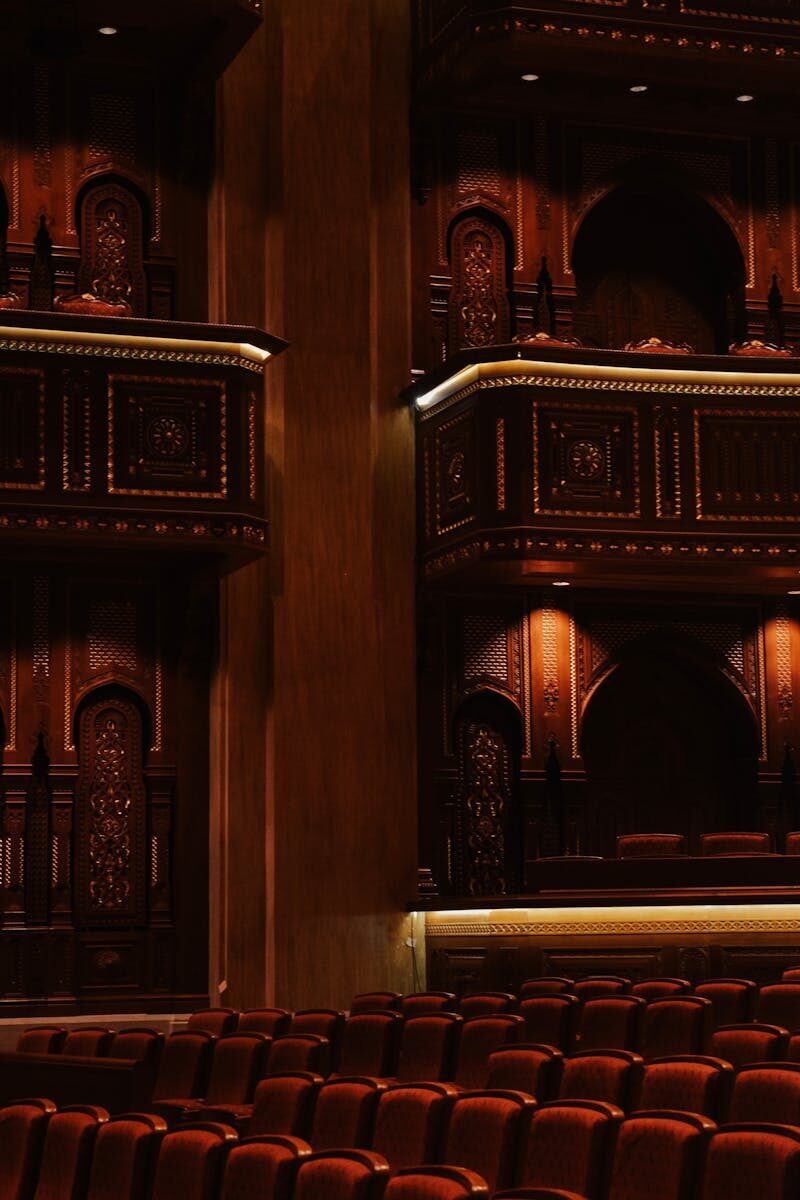 Intricate wooden detailing inside the Royal Opera House Muscat with plush seating