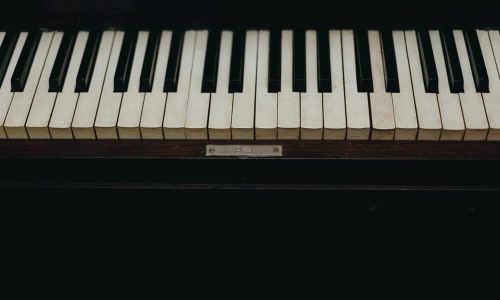 A close-up view of vintage piano keys showcasing the wear and character of the instrument.