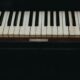 A close-up view of vintage piano keys showcasing the wear and character of the instrument.