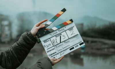 Close-up of a film clapperboard on an outdoor set, signaling scene start.