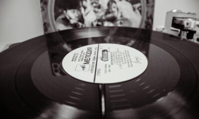 Black and white close-up of a spinning vinyl record on a turntable.