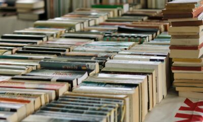 Wide view of numerous books neatly arranged at a book market, showcasing variety and abundance.