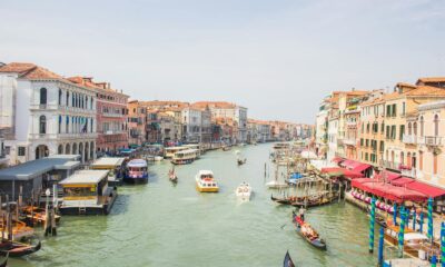 A lively view of Venice's Grand Canal featuring gondolas and historic architecture.
