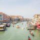 A lively view of Venice's Grand Canal featuring gondolas and historic architecture.