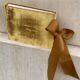 A luxurious gold velvet-covered book tied with an elegant ribbon, perfect for gifts and special occasions.