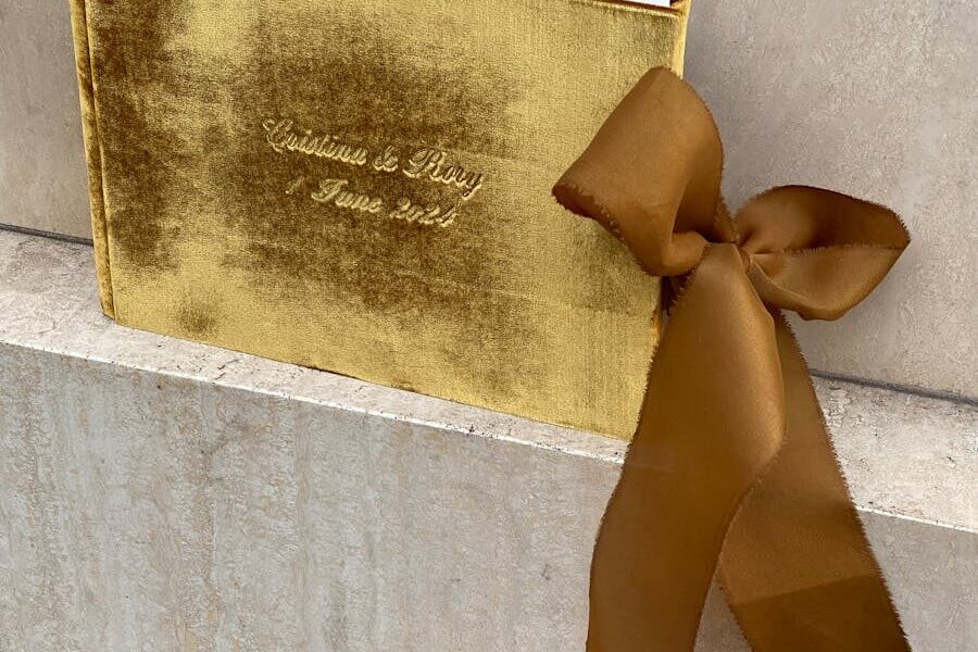 A luxurious gold velvet-covered book tied with an elegant ribbon, perfect for gifts and special occasions.