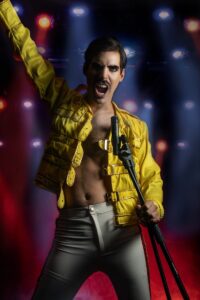Dynamic image of a rock star singing passionately on stage with vivid lights.