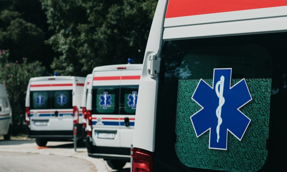 Three ambulances parked outdoors, ready for emergency healthcare situations.