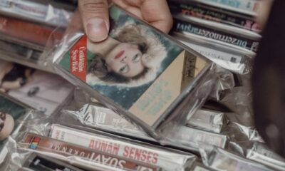 Person browsing vintage cassette tapes at an Istanbul market, evoking nostalgia for retro music lovers.