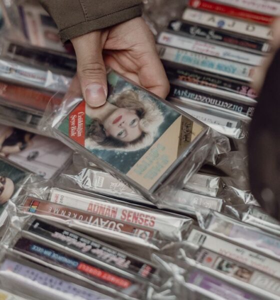 Person browsing vintage cassette tapes at an Istanbul market, evoking nostalgia for retro music lovers.