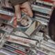 Person browsing vintage cassette tapes at an Istanbul market, evoking nostalgia for retro music lovers.
